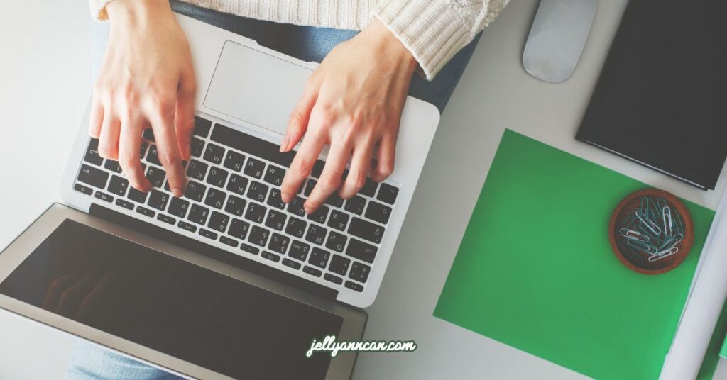 Girl typing something on a laptop.