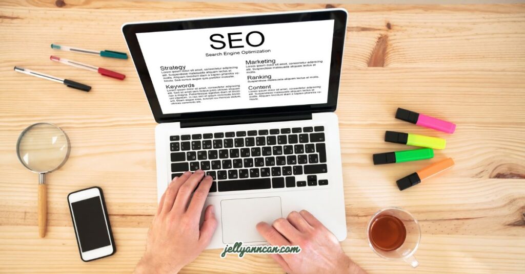 An image of a person typing on a laptop with SEO on its screen.